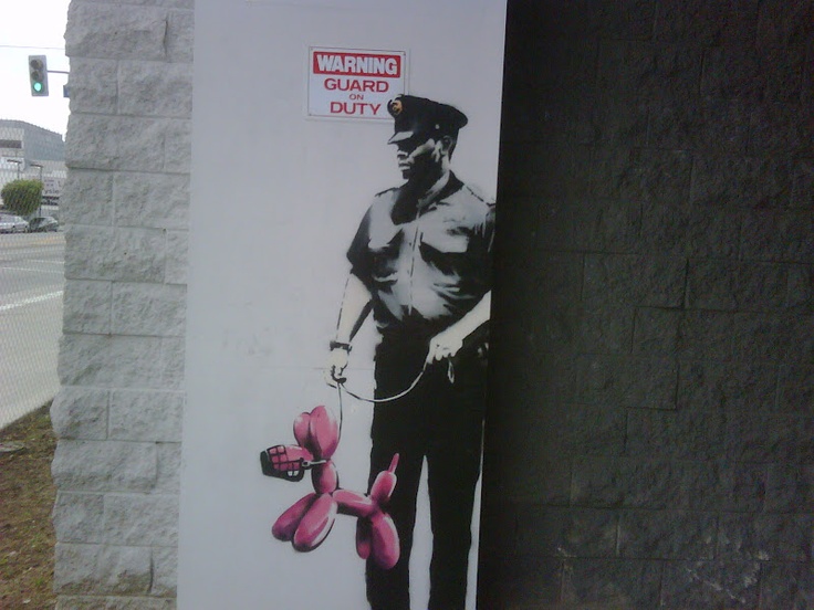 a large poster on the side of a building with a man holding a pink flower