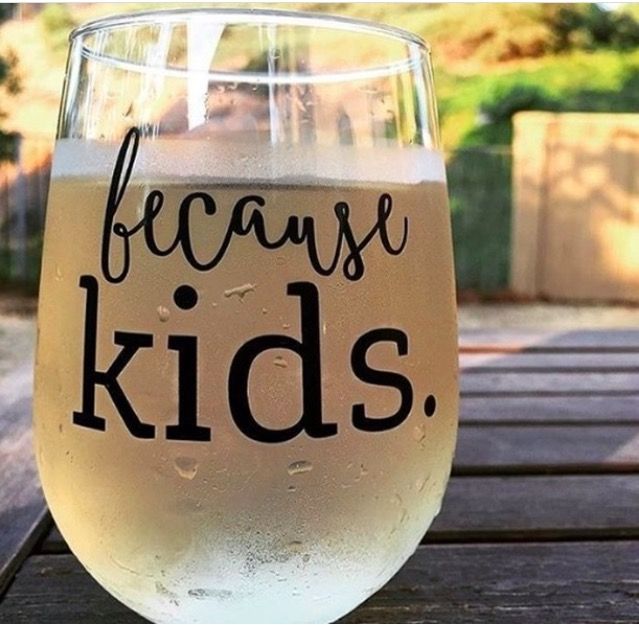 a glass filled with liquid sitting on top of a wooden table