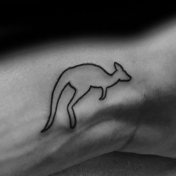 a black and white photo of a small kangaroo tattoo on the left side of the arm