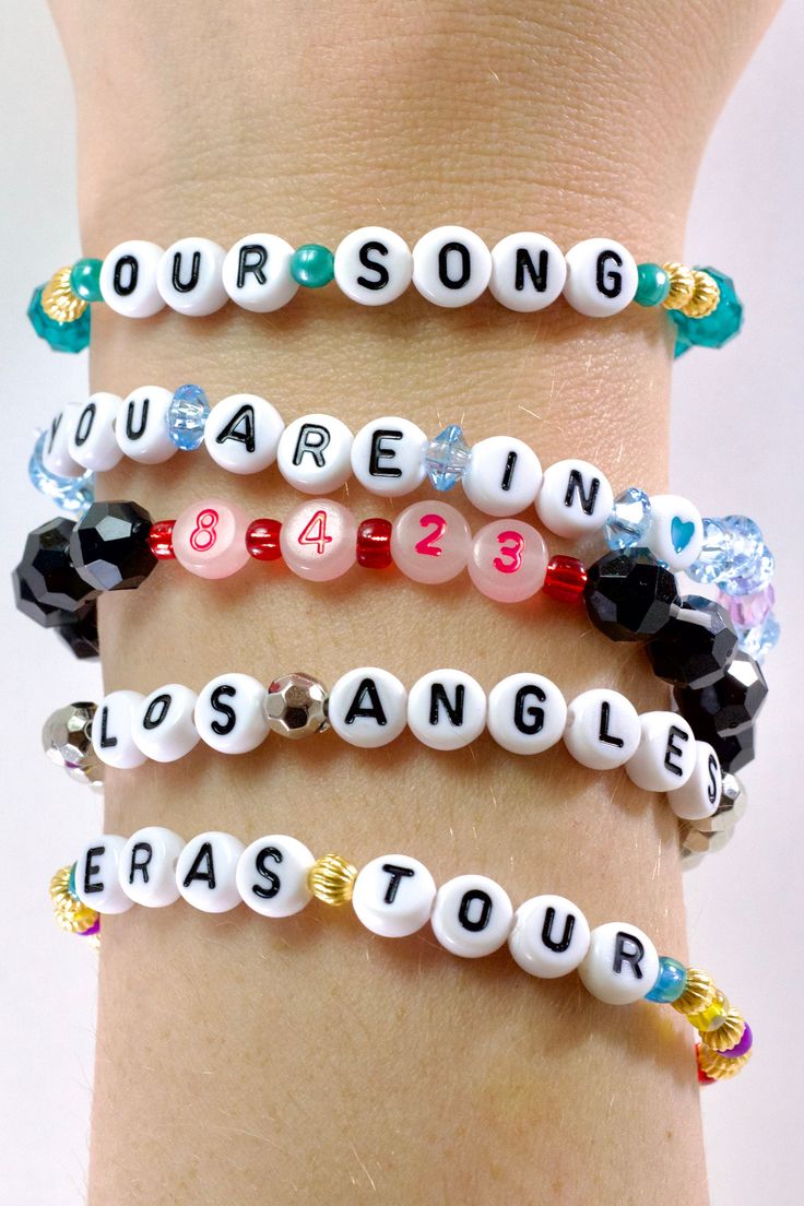 Introducing our Post-Concert Collection, Eras Tour beaded friendship bracelets! Handmade with love and care, these bracelets are a must-have for any Swiftie looking to remain in this moment & capture it, remember it!  SCREAMING CRYING THROWING UP (IYKYK)  with the announcement of the Eras Movie  we've added the option of ERAS MOVIE friendship bracelets. 🥳 ERAS TOUR Surprise Song Set includes:  - Your Concert Date  - Your Surprise Song 1  - Your Surprise Song 2  - City of Your Tour Stop  - Eras Tour (with all eras colored beads!)  ERAS MOVIE Set includes:  - Your Movie Showing Date  - Song title of your choice 1  - Song title of your choice 2  - City of Your Theater  - Eras Movie (will all eras colored beads!)   ️🖤🤎💙 PS let us know what era you dressed/are dressing as & we'll match the Eras Movie Bracelets, Our Song Bracelet, Charmbracelet Era, Eras Tour Bracelet Trading, Bracelet Trading Eras Tour, Eras Tour Bracelets Without E, Unhinged Eras Tour Bracelets, Capture It Remember It, Friendship Bracelets Eras Tour