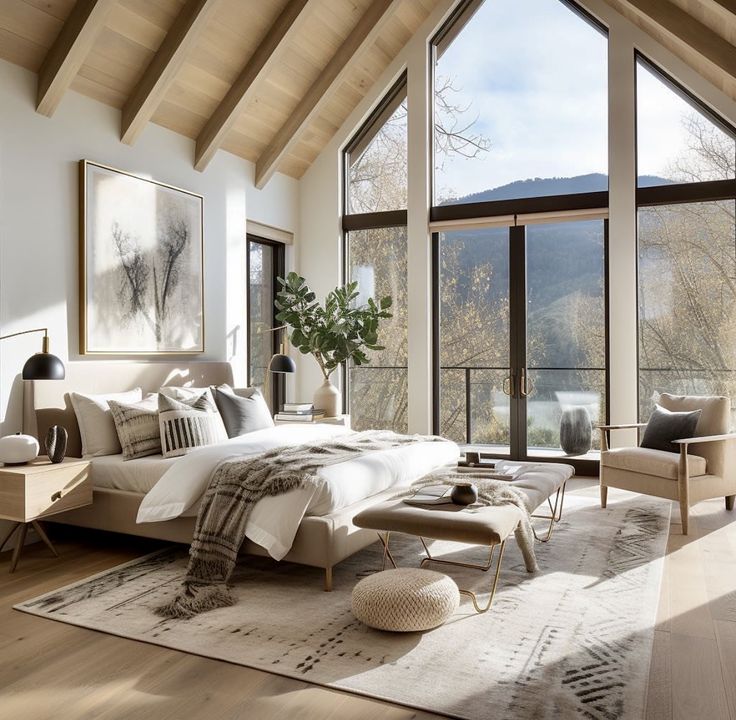 a bedroom with large windows overlooking the mountains