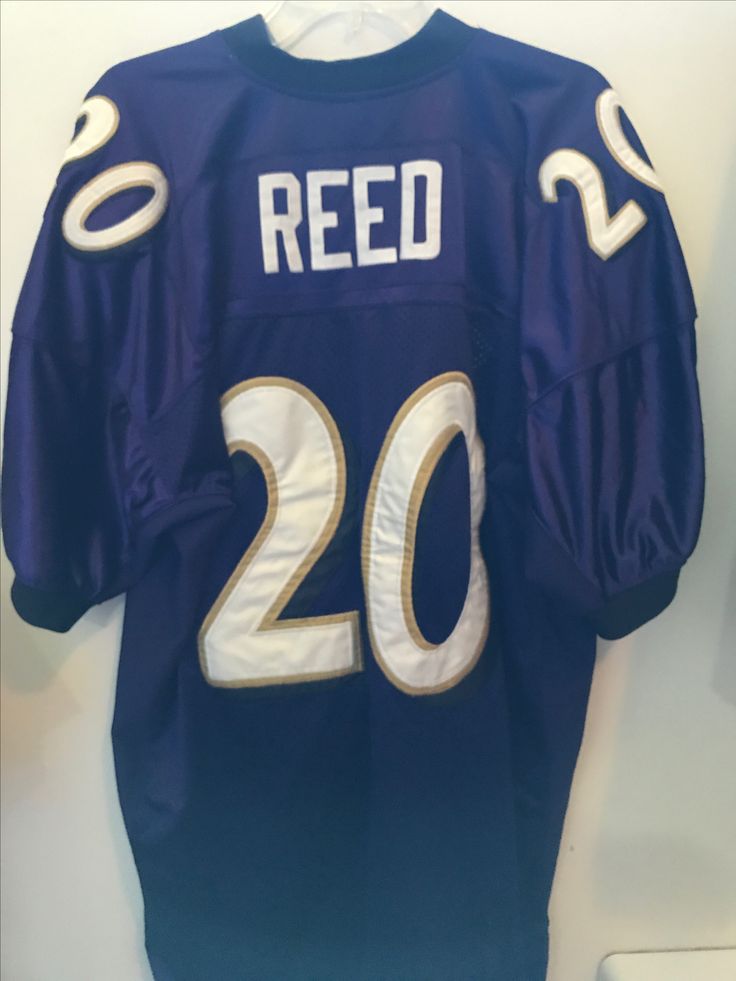 a football jersey hanging on a wall with the numbers 20 and 30 printed on it