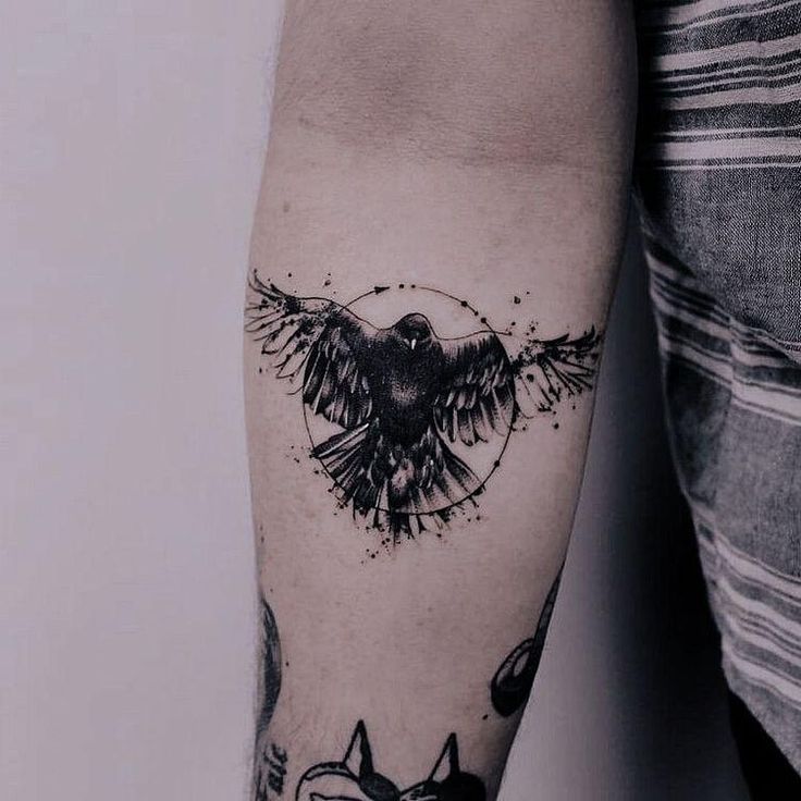 a black and white tattoo on the arm of a man with an eagle, stars and circles