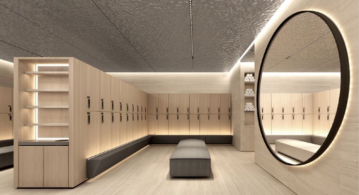 an empty locker room with benches and mirrors on the wall, along with shelves filled with shoes