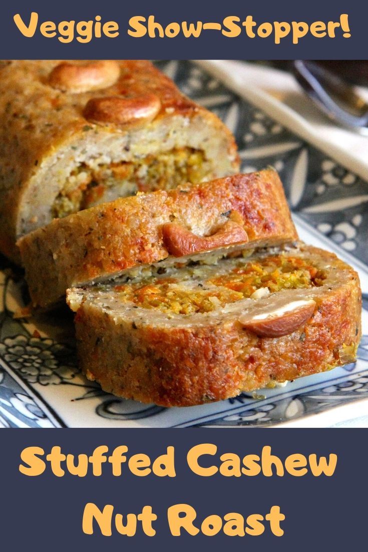 a loaf of stuffed cashew nut roast on a blue and white plate with the words, veggie show - stopper