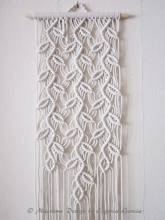 a white wall hanging on the side of a wall