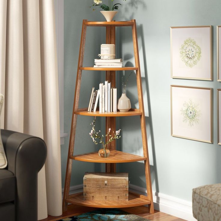 a corner shelf with books and flowers on it in the corner of a living room