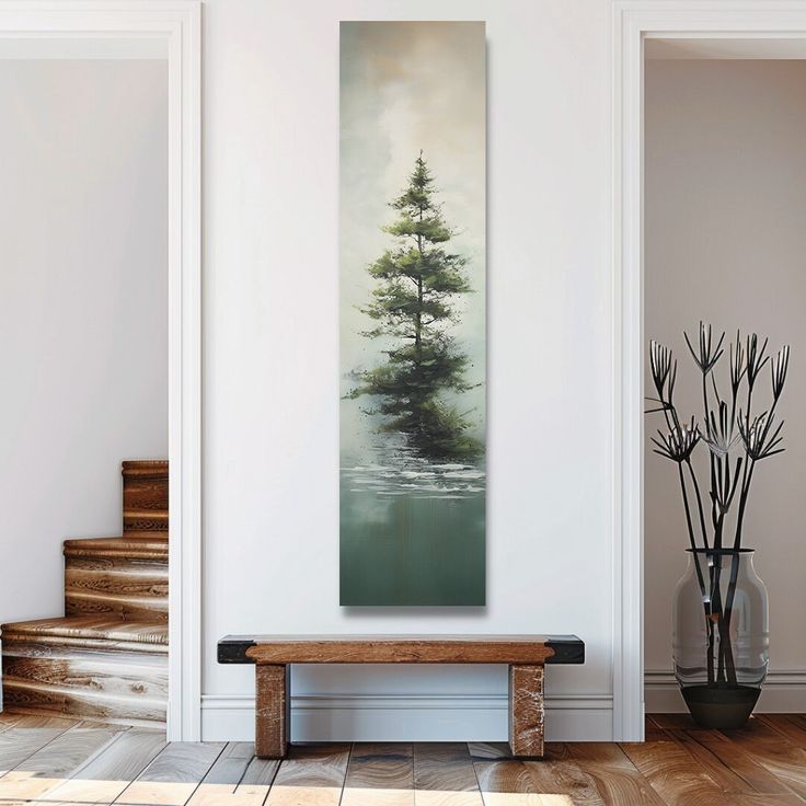 a painting hanging on the wall next to a wooden bench and vase with plants in it