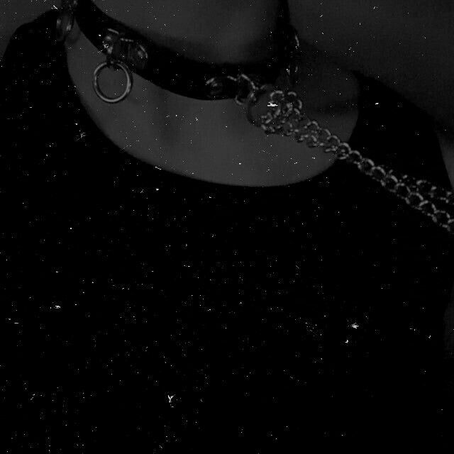 black and white photograph of a woman wearing a choker with chains around her neck