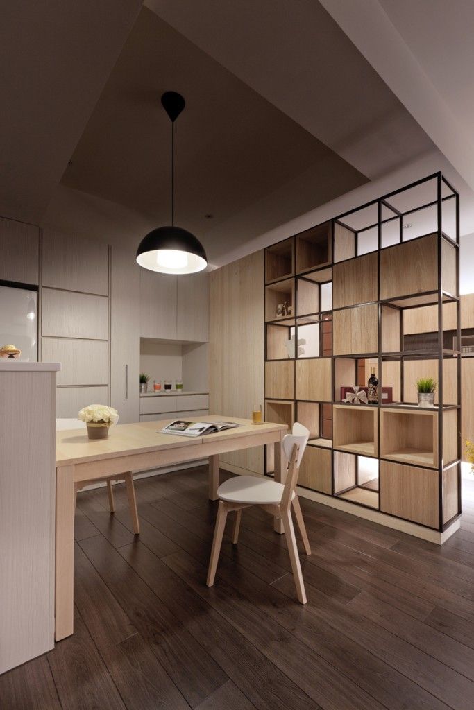 a dining room table with chairs and shelves on the wall