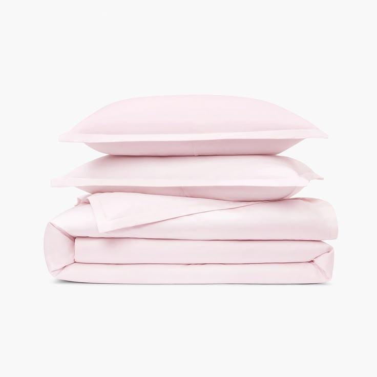 the pink sheets and pillow cases are stacked on top of each other in front of a white background