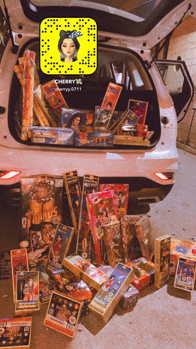 the trunk of a car is full of toys and books for sale in an alleyway