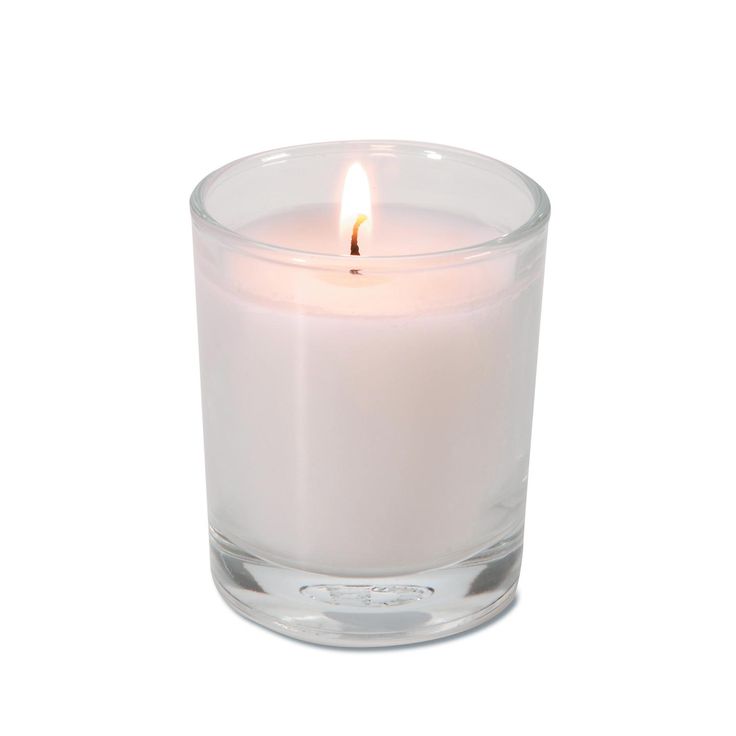 a white candle in a glass container