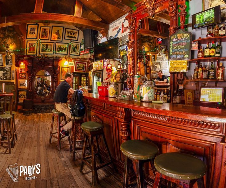 a man sitting at a bar in a pub