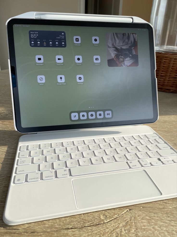 an open laptop computer sitting on top of a wooden table