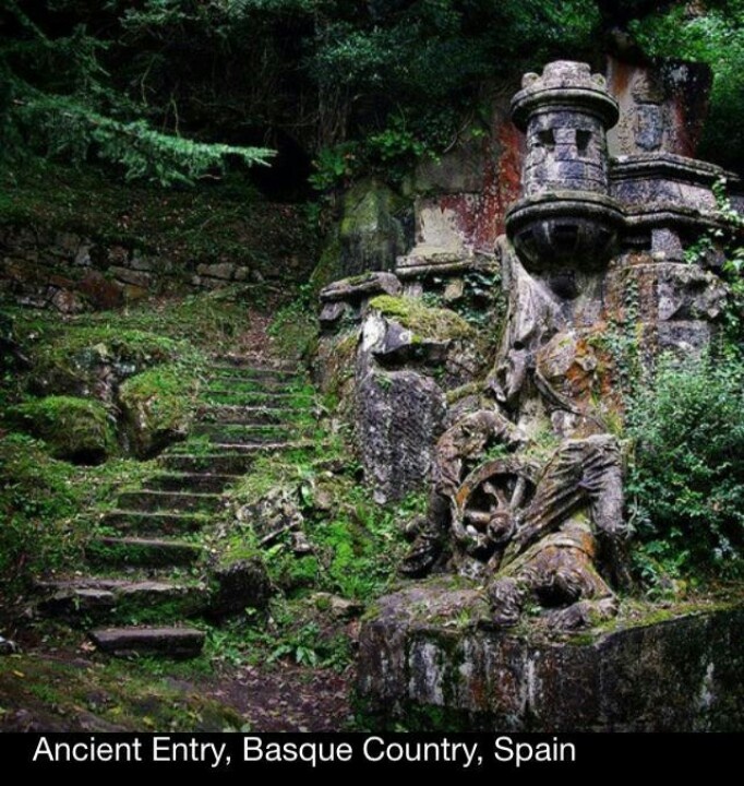 the stairs lead up to an old stone structure in the woods with moss growing on it