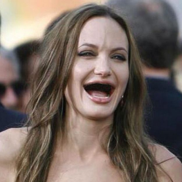 a woman with her mouth wide open and an evil look on her face is laughing