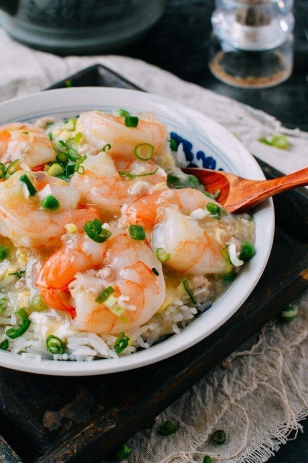 a bowl filled with rice and shrimp on top of a table