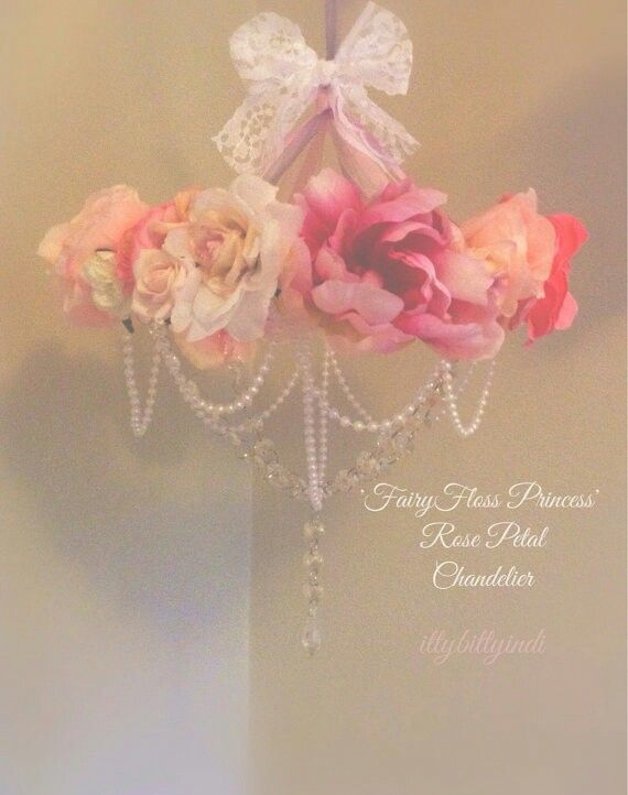 pink and white flowers with pearls hanging from a chandelier