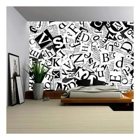 a bedroom with black and white wallpaper that has letters all over the room on it