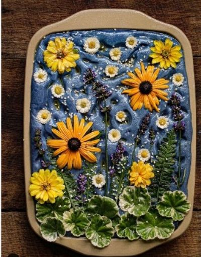 a ceramic plate with flowers and plants on it