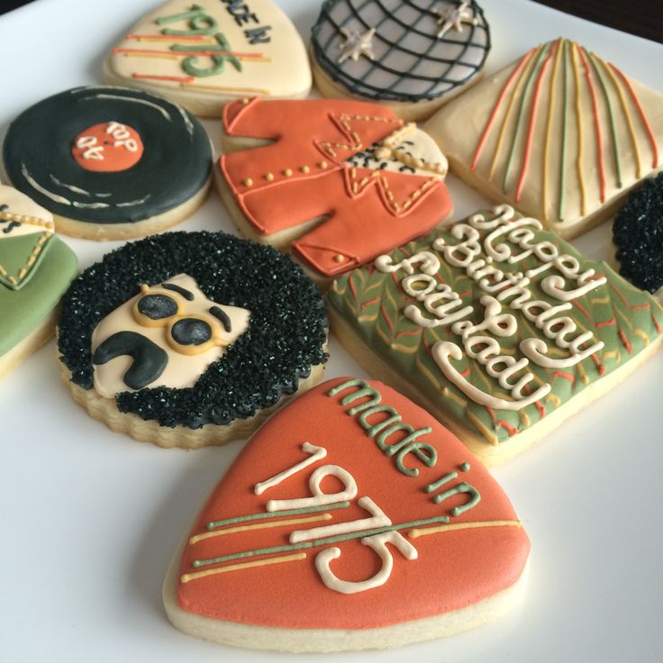 decorated cookies are arranged on a white plate