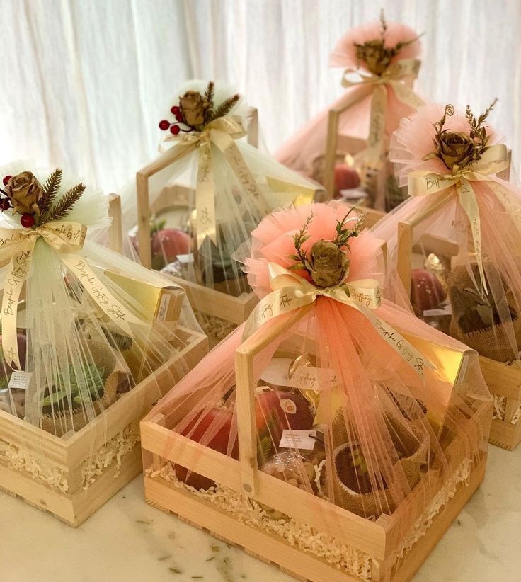 four wooden boxes filled with assorted chocolates in organ netting bags on top of a table