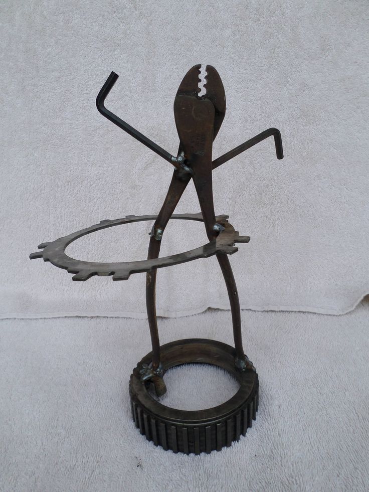 a metal sculpture with a football on it