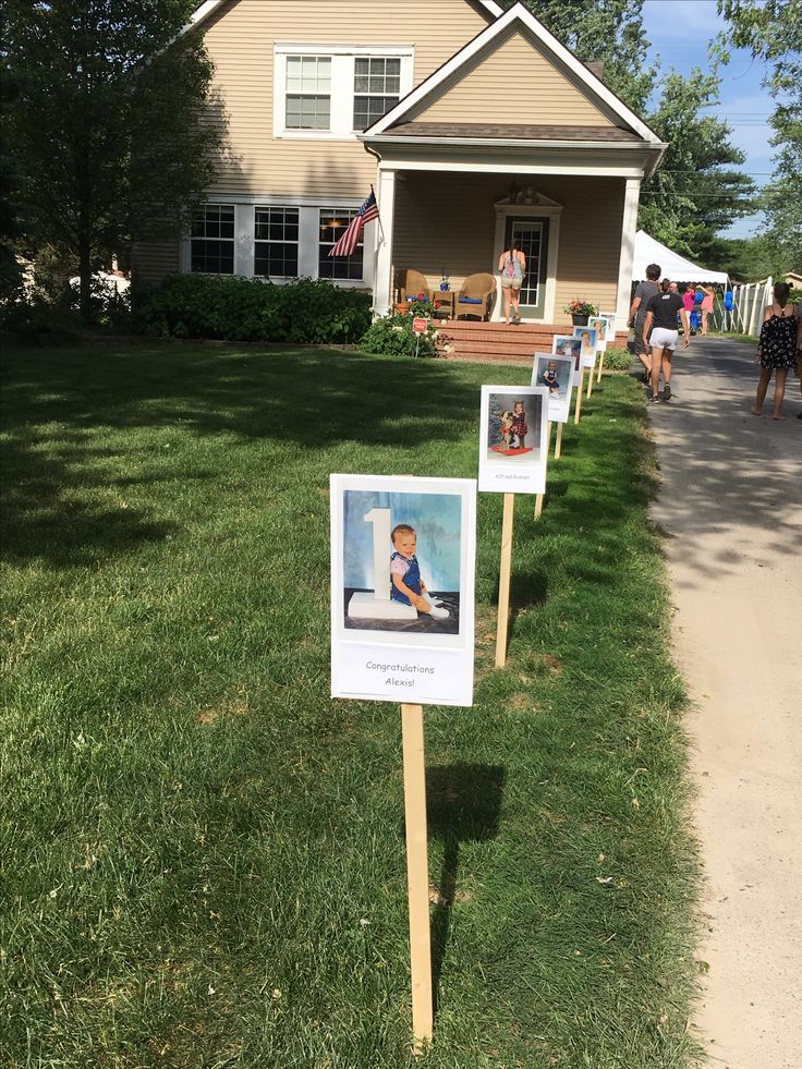 some signs in front of a house with pictures on them