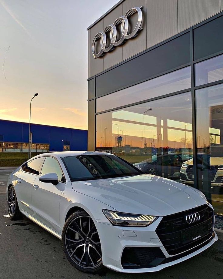 a white car parked in front of a building