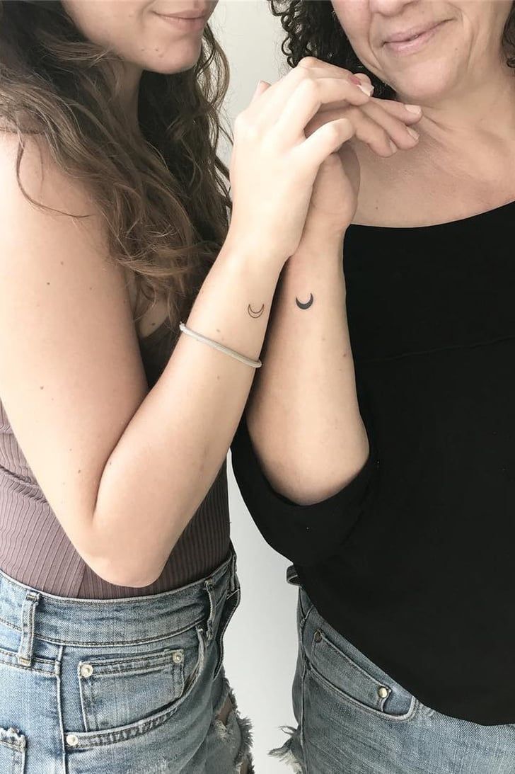 two women standing next to each other with tattoos on their arms