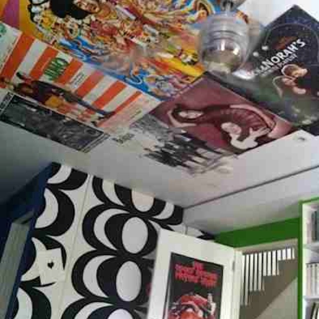 the ceiling is covered with posters and movies