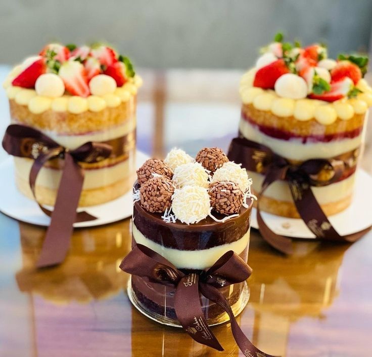 two desserts with chocolate and strawberries on top