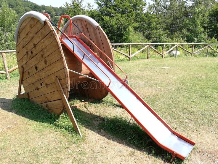 a wooden slide in the middle of a field