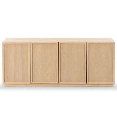 the sideboard with four doors and three drawers is shown in light brown oak wood