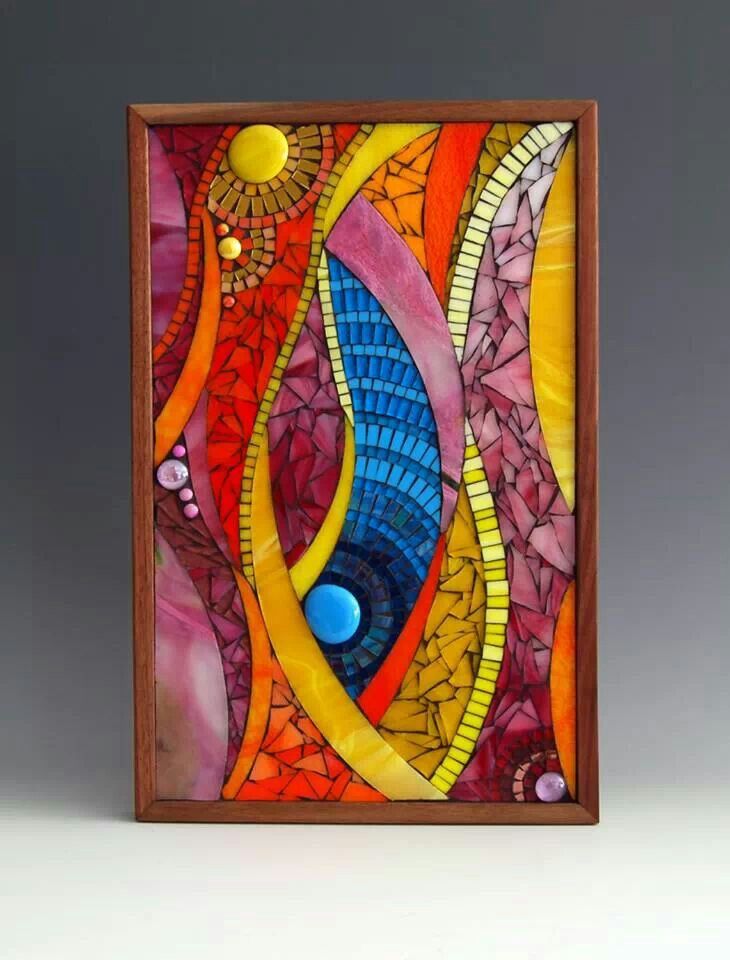 a colorful glass painting in a wooden frame