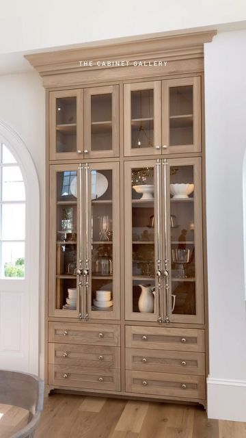 an empty china cabinet in the corner of a room