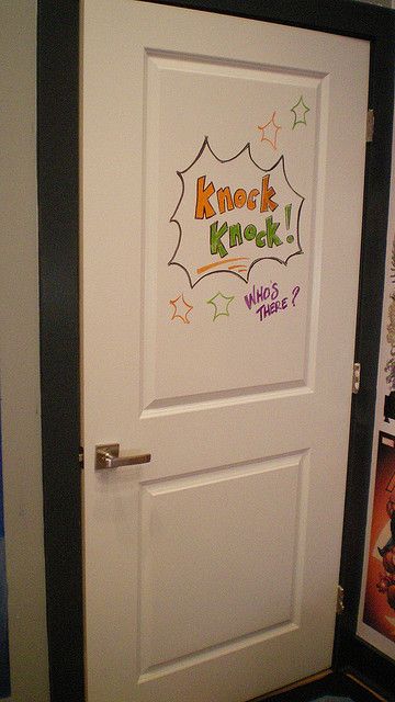 a white door with the words knock knock written on it in front of a movie poster