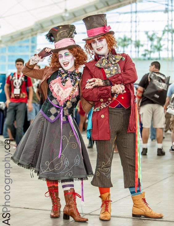 two people dressed in costumes standing next to each other