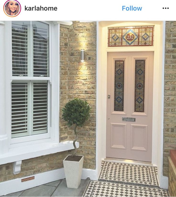 a white front door sitting next to a brick building