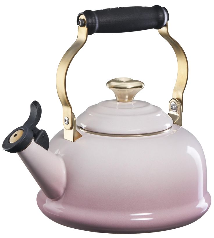 a pink and gold tea kettle with a black handle