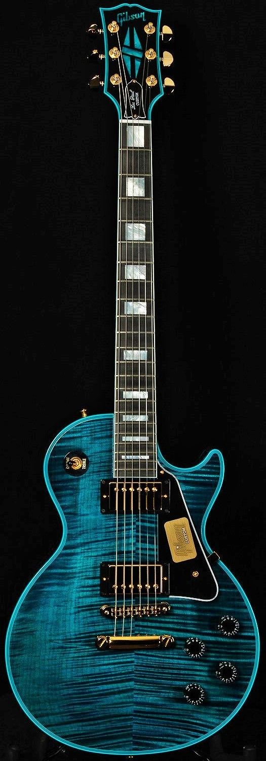 an electric guitar with a blue body and black background