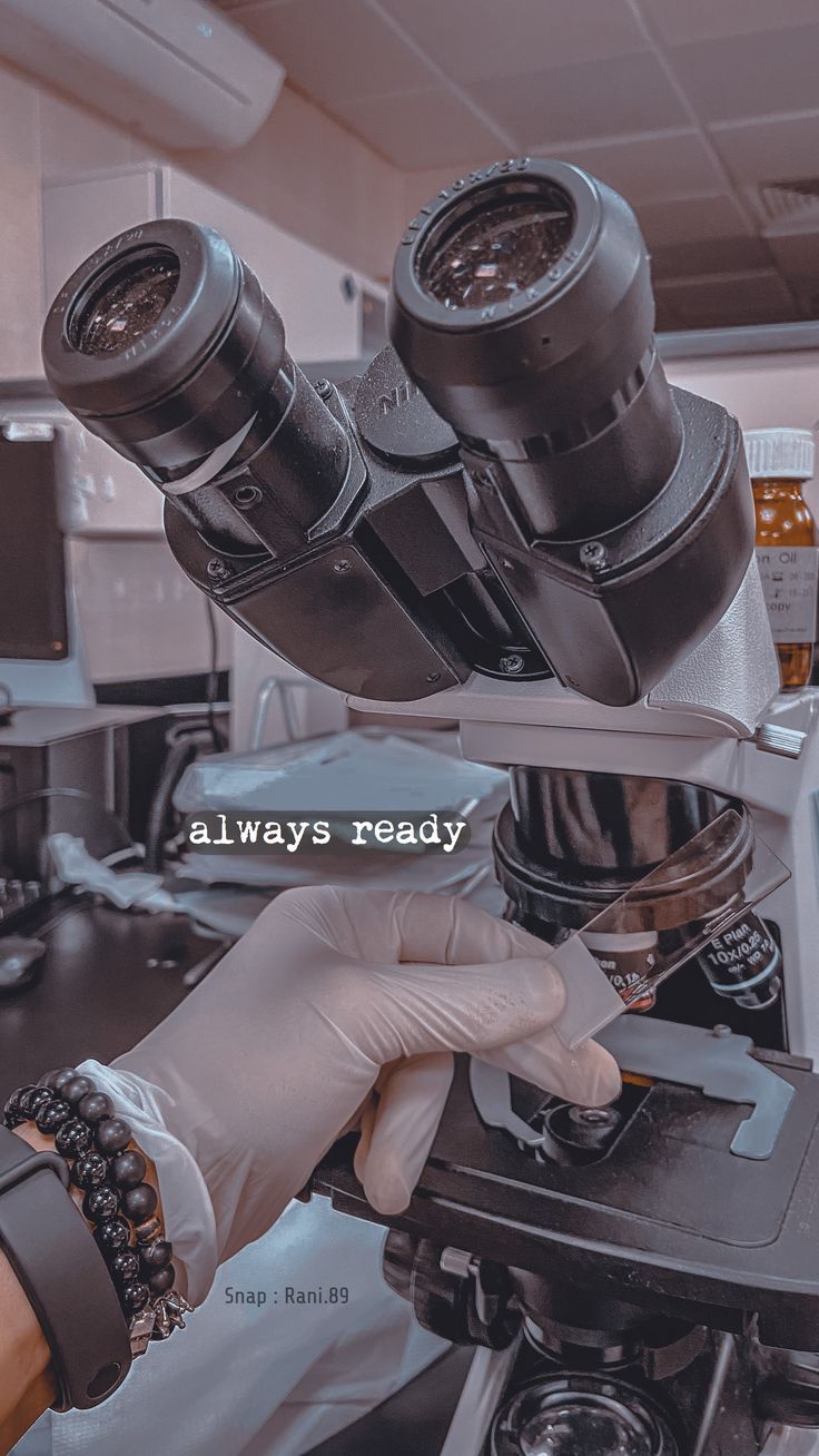 a person in white gloves looking through a microscope with the words always ready on it