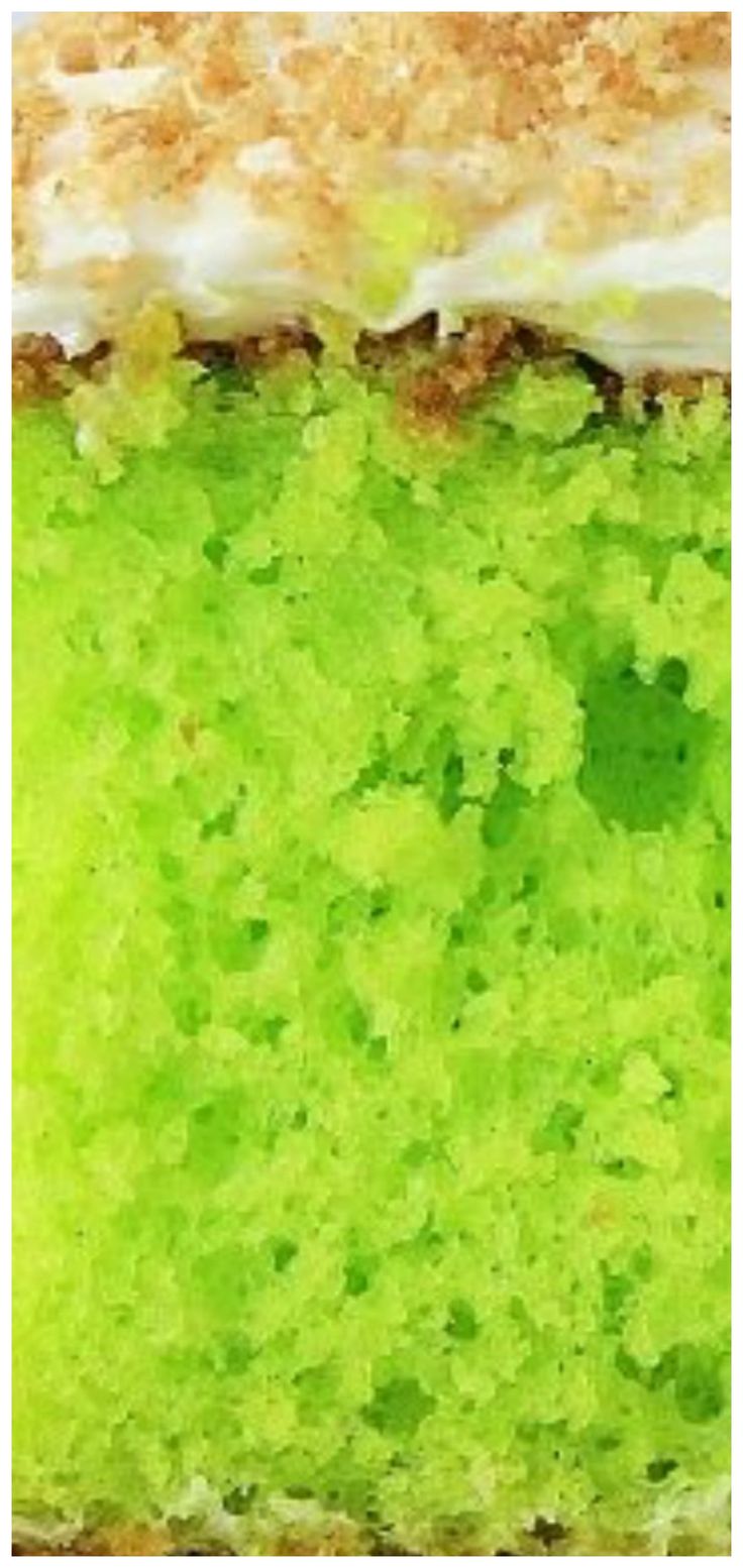 a green cake with white frosting and sprinkles on it's edges