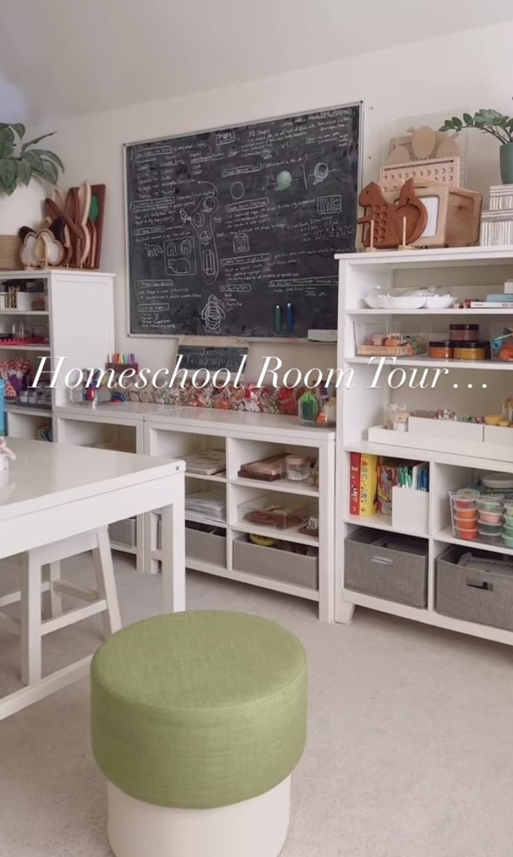 a room filled with lots of white furniture next to a chalkboard