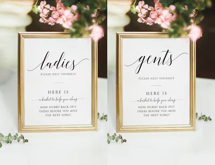 two gold frames with pink flowers and greenery are on top of a white table