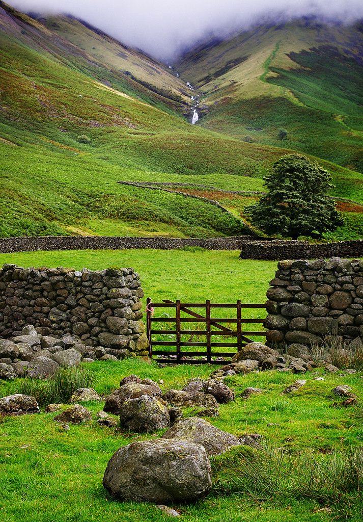 an instagram page with the image of a farm and mountains in the background