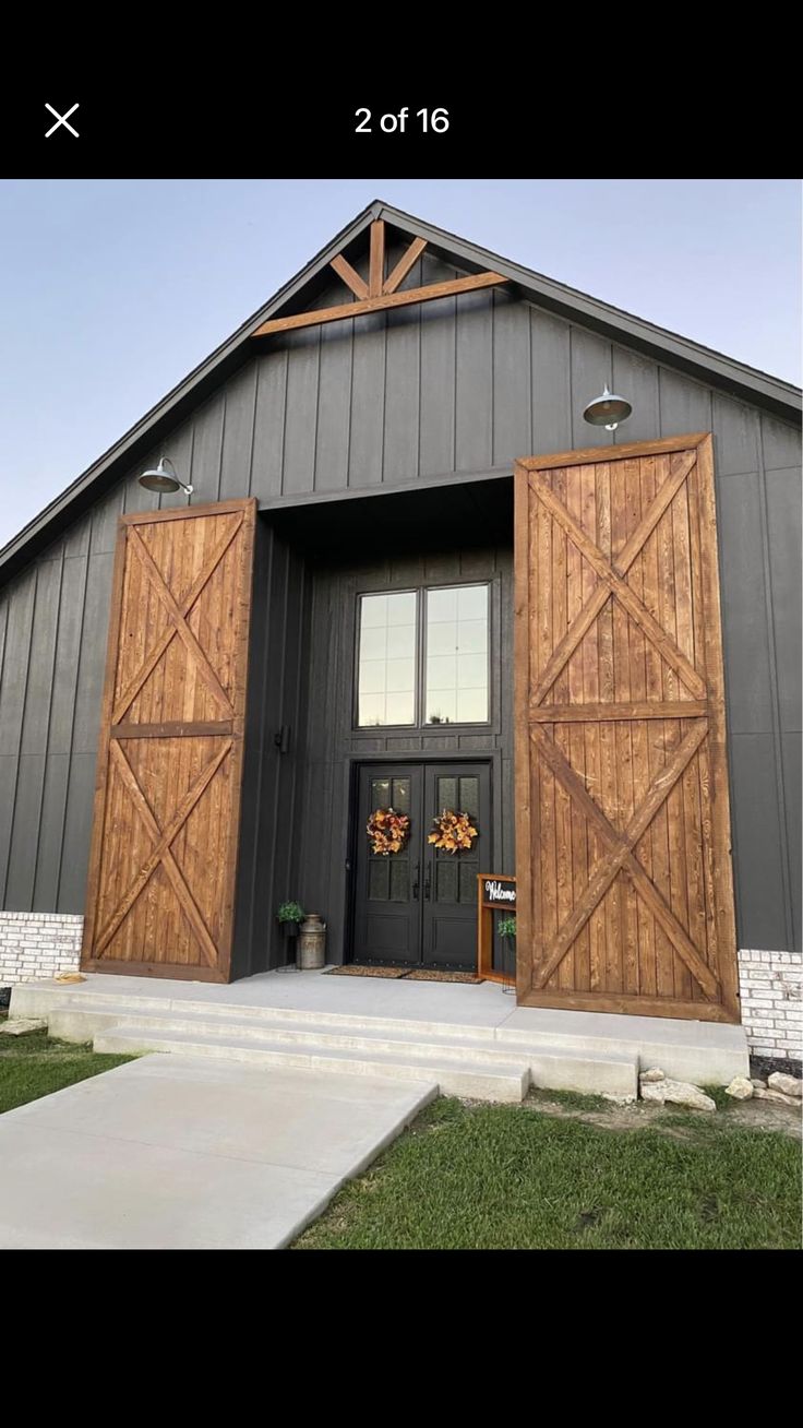 an open barn door with two wreaths on the front and one in the back