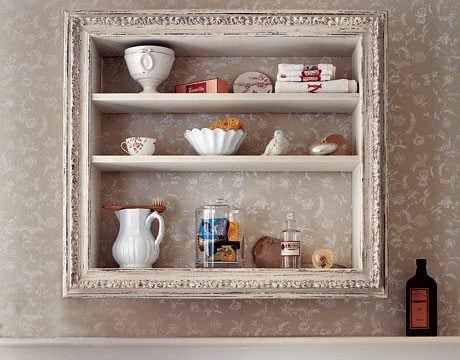 a shelf filled with dishes and cups on top of a counter