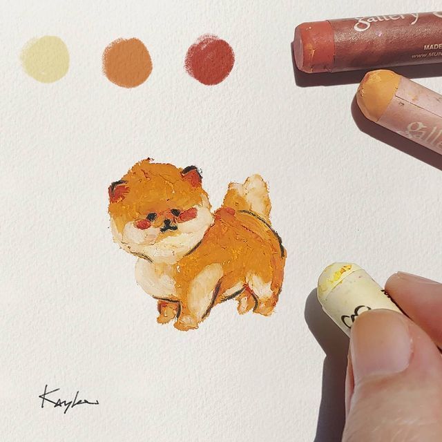 a drawing of a small dog on paper with crayons and markers around it